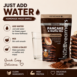 Chocolate protein pancake and waffle mix packaging with a glass of water on a beige background.