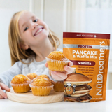 Child holding a muffin with NutDreamers Protein Pancake & Waffle Mix packaging in the foreground.